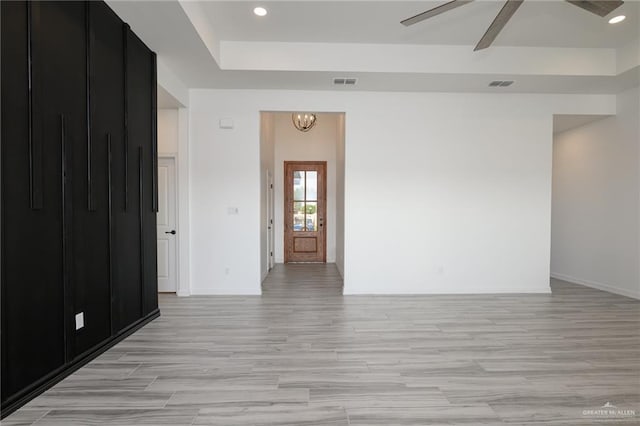 unfurnished room with visible vents, baseboards, and light wood-style floors