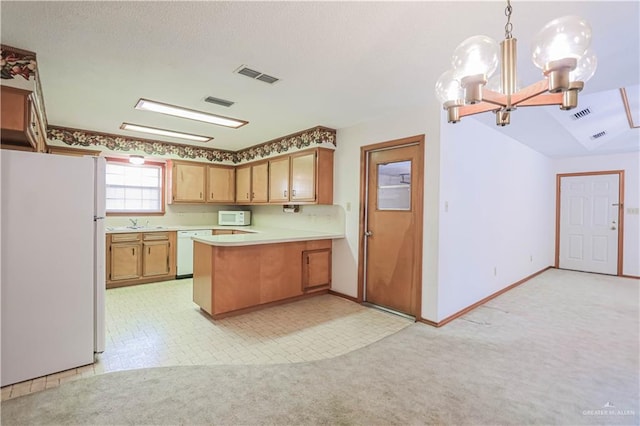 kitchen featuring kitchen peninsula, light carpet, white appliances, and decorative light fixtures