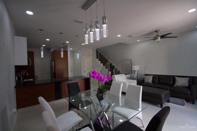 dining room with ceiling fan and sink