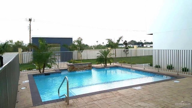 view of swimming pool with pool water feature