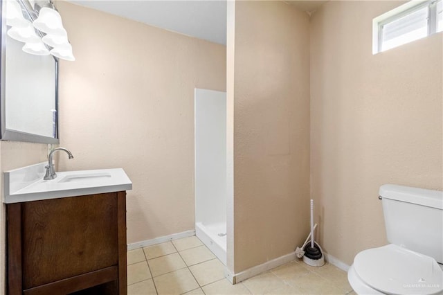 bathroom featuring tile patterned flooring, vanity, a shower, and toilet