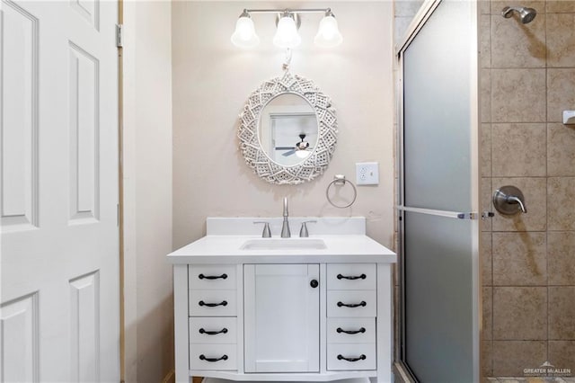 bathroom with vanity and a shower with shower door