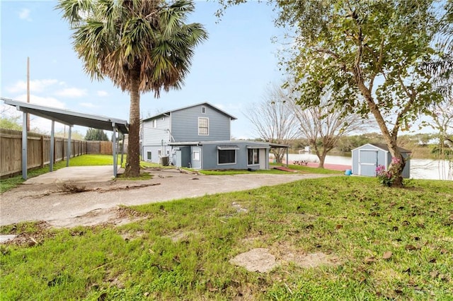 view of yard with a storage shed and a carport