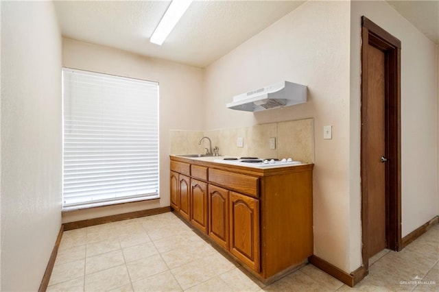 kitchen with sink, decorative backsplash, and white electric stovetop