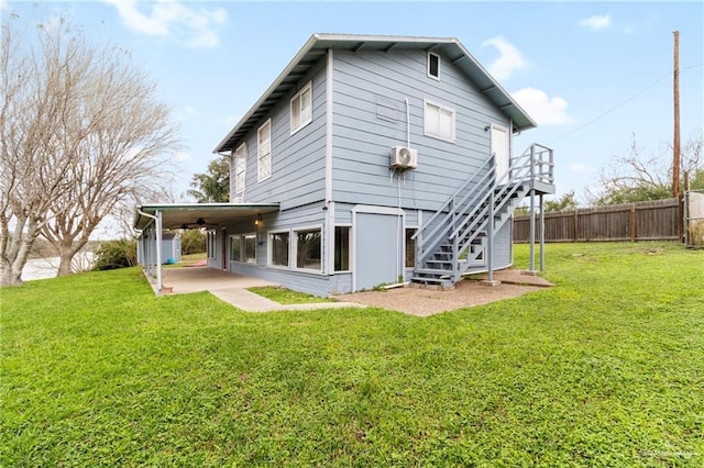 rear view of property with a yard and a patio