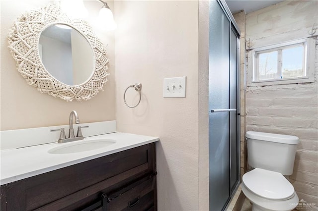 bathroom with vanity, an enclosed shower, and toilet