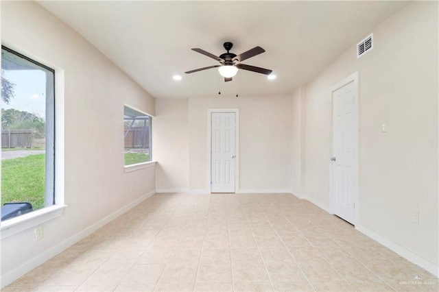 empty room featuring light tile patterned floors and ceiling fan