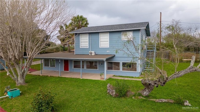 rear view of property with a yard and a patio area