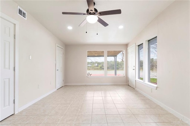 tiled empty room featuring ceiling fan