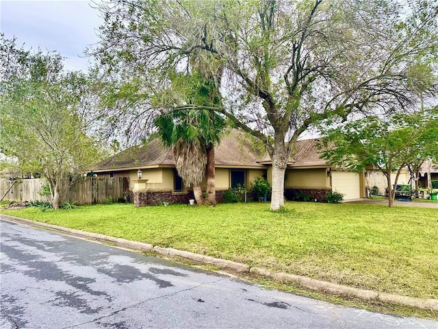 ranch-style home with a garage and a front lawn