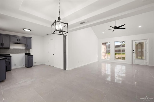 kitchen featuring pendant lighting, backsplash, ceiling fan with notable chandelier, gray cabinets, and light tile patterned flooring