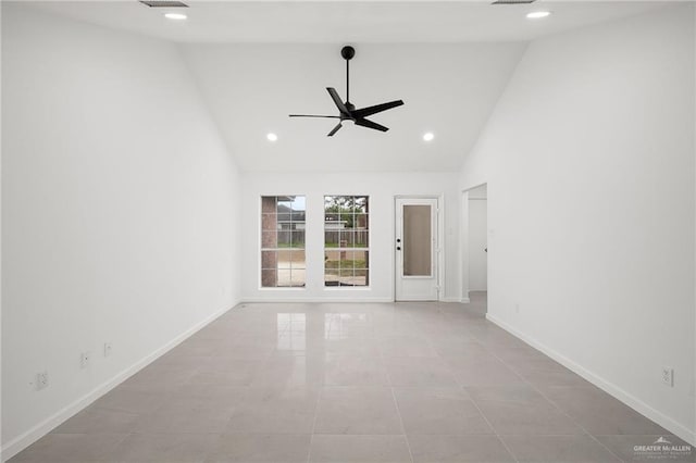 empty room featuring ceiling fan, high vaulted ceiling, and light tile patterned floors