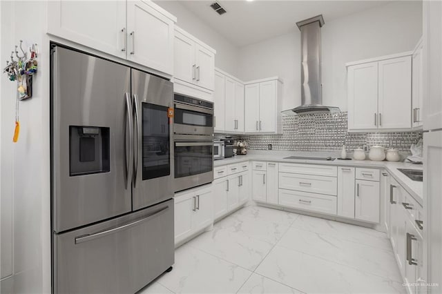 3108 E Bella Vista Ave, Alton, TX 78573 - kitchen featuring appliances with stainless steel finishes, wall chimney exhaust hood, light marble finish floors, light countertops, and white cabinetry