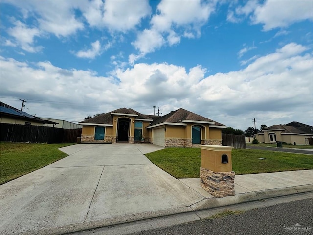 view of front of home featuring a front yard and a garage