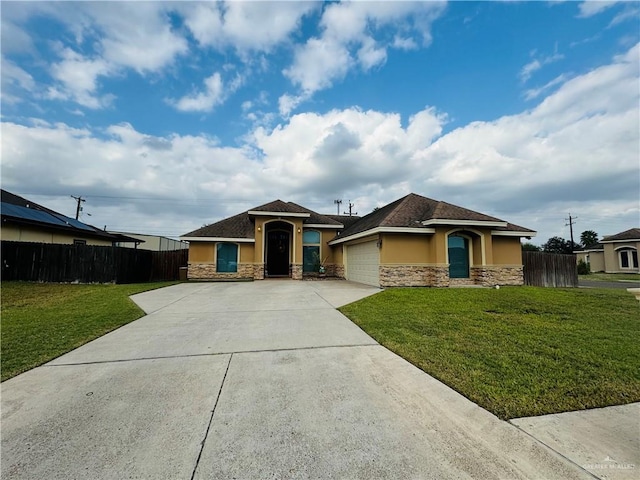 view of front facade with a front yard and a garage