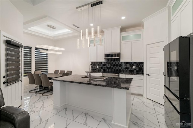 kitchen with recessed lighting, a sink, marble finish floor, freestanding refrigerator, and tasteful backsplash