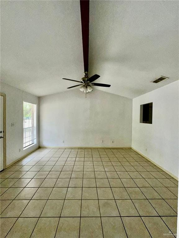 spare room featuring light tile patterned floors, a textured ceiling, ceiling fan, and lofted ceiling