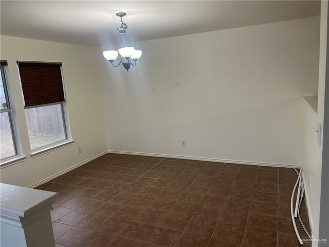 empty room with an inviting chandelier