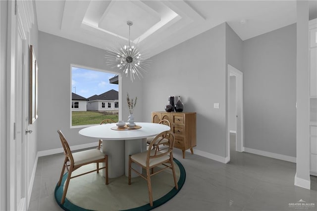 1012 Azalea St, Mission, TX 78573 - tiled dining area with a tray ceiling, a notable chandelier, and baseboards