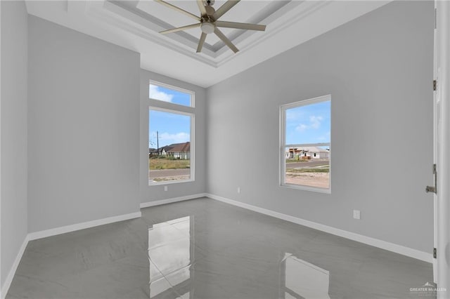 1012 Azalea St, Mission, TX 78573 - spare room with a ceiling fan, a raised ceiling, and baseboards