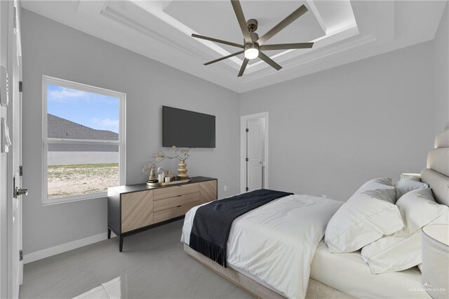 1012 Azalea St, Mission, TX 78573 - bedroom featuring baseboards, a tray ceiling, and ceiling fan