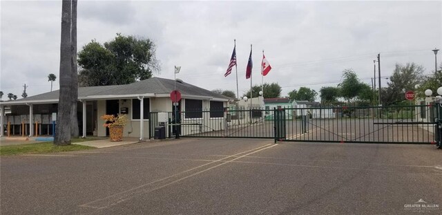 2422 Starling Cir E, Palmview, TX 78572 - view of asphalt road with traffic signs, a gate, and a gated entry