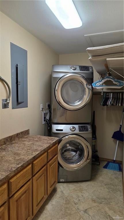 2422 Starling Cir E, Palmview, TX 78572 - washroom featuring stacked washer and clothes dryer, electric panel, and cabinet space