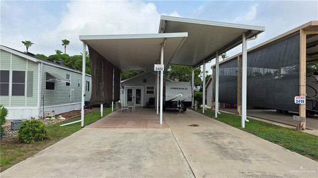 2422 Starling Cir E, Palmview, TX 78572 - view of parking featuring driveway and a carport