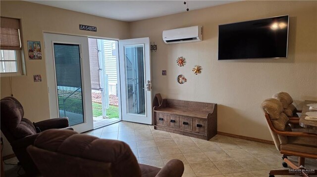 2422 Starling Cir E, Palmview, TX 78572 - living room featuring a wall mounted AC, light tile patterned floors, and baseboards