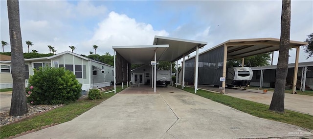 2422 Starling Cir E, Palmview, TX 78572 - view of front of property featuring concrete driveway and a detached carport