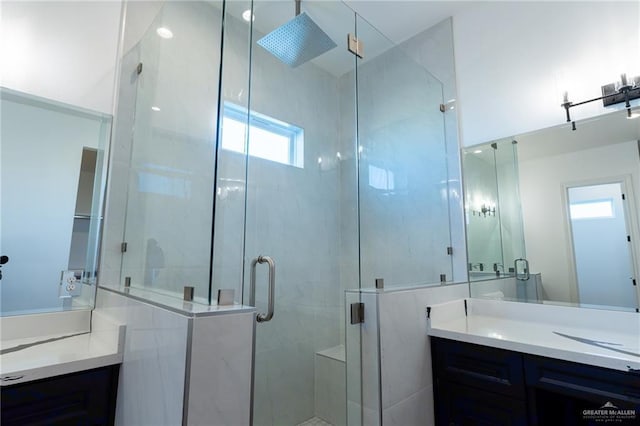 full bath with vanity and a shower stall