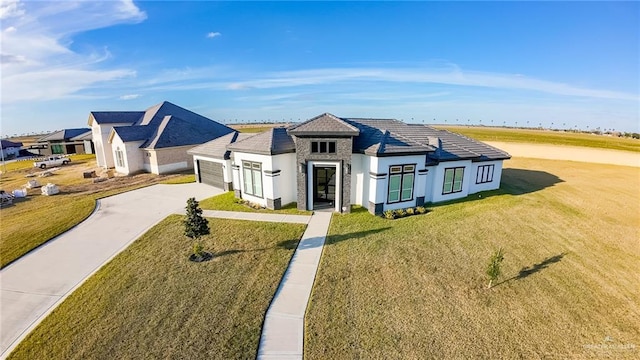 view of front facade with concrete driveway, stone siding, stucco siding, an attached garage, and a front yard