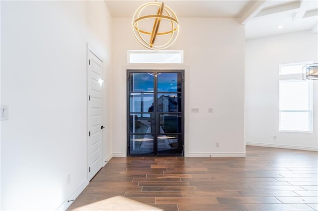 foyer entrance featuring dark wood-style floors and baseboards