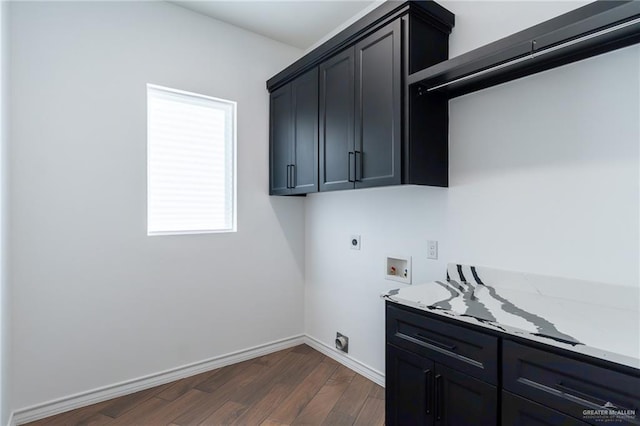 clothes washing area featuring dark wood-style flooring, hookup for a washing machine, cabinet space, electric dryer hookup, and baseboards