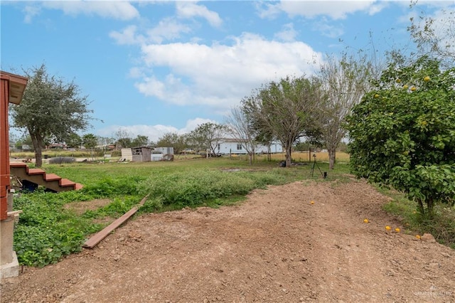 view of yard with a rural view