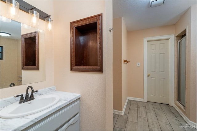 bathroom with vanity and an enclosed shower