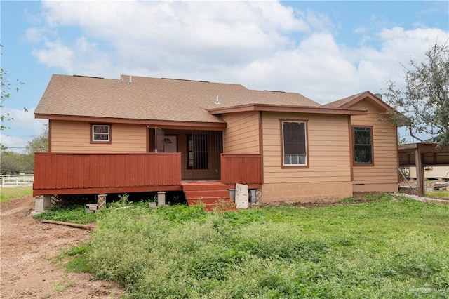 back of property featuring a yard and a deck