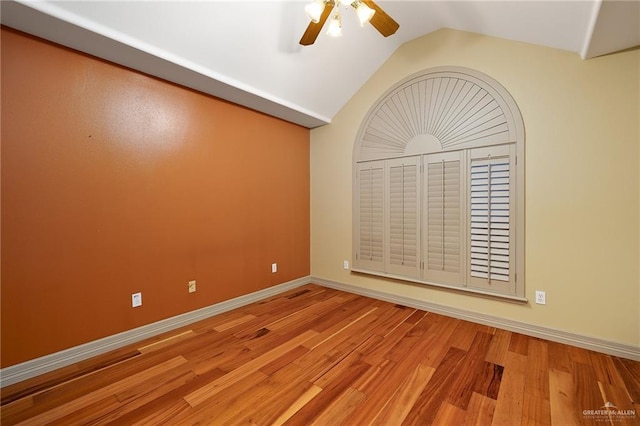 unfurnished room with lofted ceiling, ceiling fan, and light hardwood / wood-style flooring