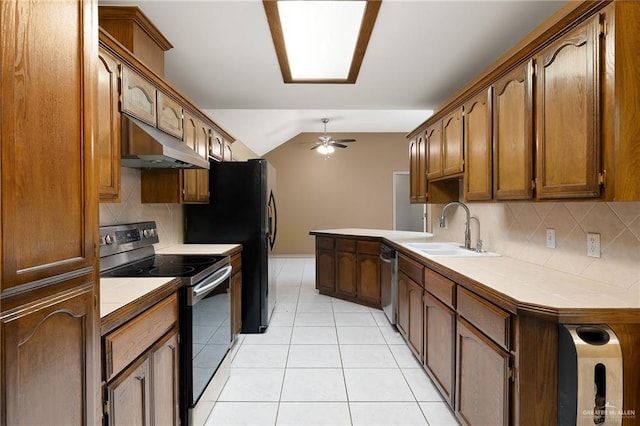 kitchen with sink, light tile patterned floors, ceiling fan, stainless steel appliances, and vaulted ceiling