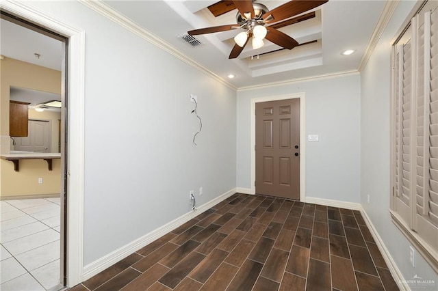 entrance foyer featuring crown molding, ceiling fan, a tray ceiling, and dark hardwood / wood-style flooring