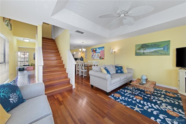 210 W Oleander St Unit B, South Padre Island, TX 78597 - living area featuring stairs, wood finished floors, a raised ceiling, ceiling fan, and a chandelier