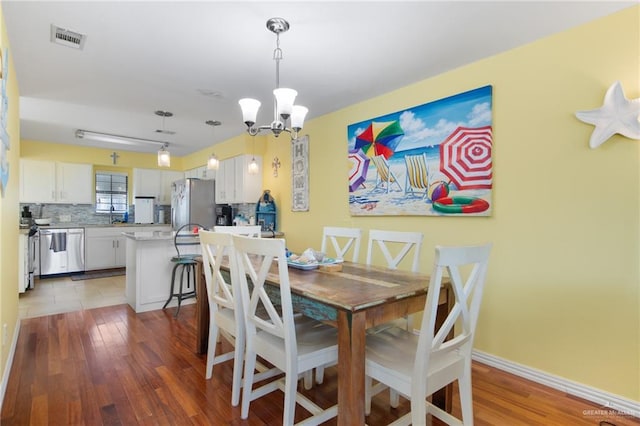 210 W Oleander St Unit B, South Padre Island, TX 78597 - dining space with a chandelier and light wood-style floors