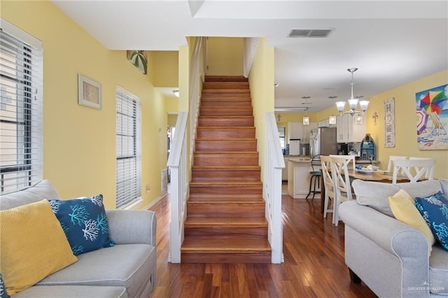 210 W Oleander St Unit B, South Padre Island, TX 78597 - staircase featuring wood finished floors, plenty of natural light, and a chandelier