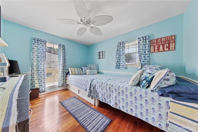 210 W Oleander St Unit B, South Padre Island, TX 78597 - bedroom featuring multiple windows, wood finished floors, and ceiling fan
