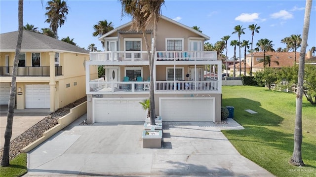 210 W Oleander St Unit B, South Padre Island, TX 78597 - beach home with a balcony, a garage, stucco siding, driveway, and a front lawn