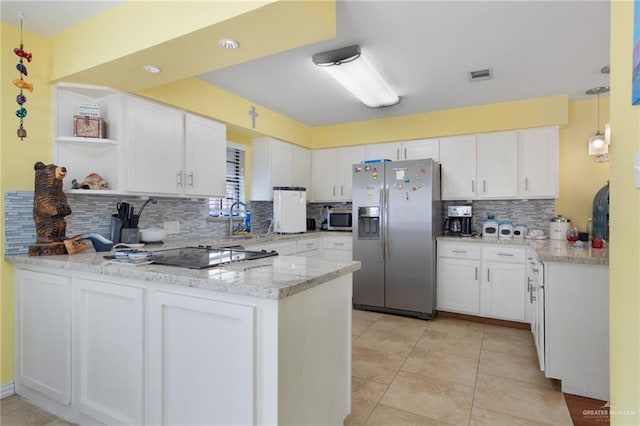 210 W Oleander St Unit B, South Padre Island, TX 78597 - kitchen with stainless steel appliances, a peninsula, backsplash, and white cabinetry