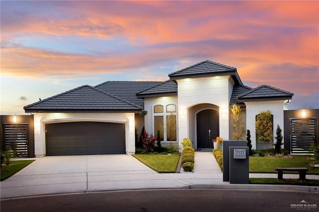 view of front of property featuring a lawn and a garage