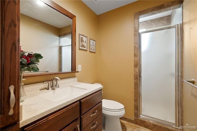 bathroom with vanity, toilet, and an enclosed shower