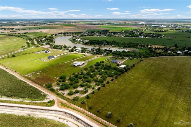 birds eye view of property featuring a rural view and a water view