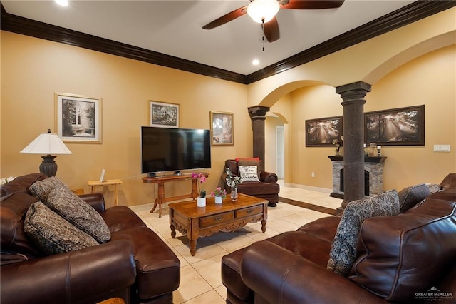 tiled living room with ceiling fan, ornate columns, and ornamental molding